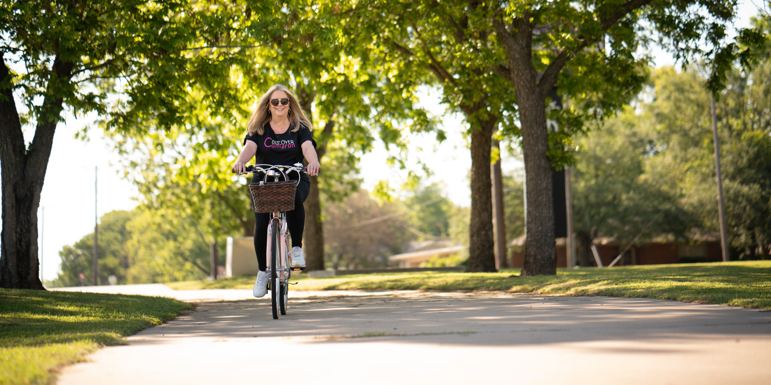 A woman riding her bike down a trail